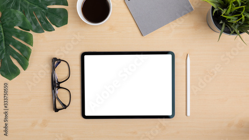 Wooden Table Office desk top view design workspace layout center top show mock up tablet isolated for insert on screen near have glasses and pen upper space have leaf, coffee cup, plant