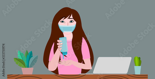 Woman is working on a laptop at home and sanitizing hands for preventing corona virus or covid-19