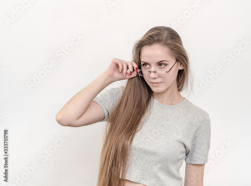 Sexy girl with long hair in glasses looking. Education, optics,
