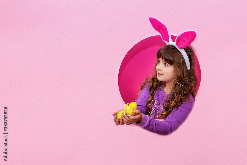 Funny happy child girl with Easter eggs and bunny ears
