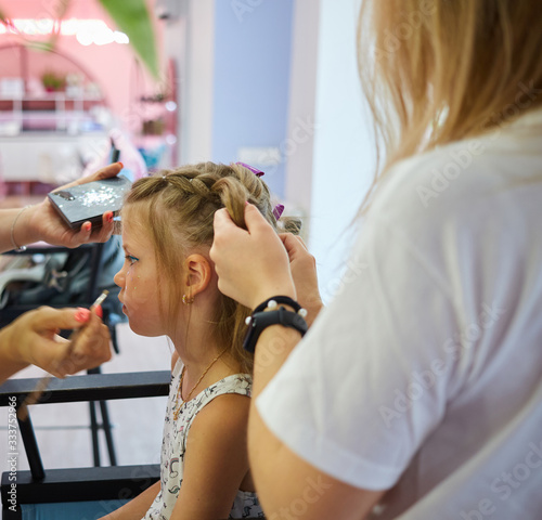 Children make up. Glitter makeup. Sparkles on cheek.