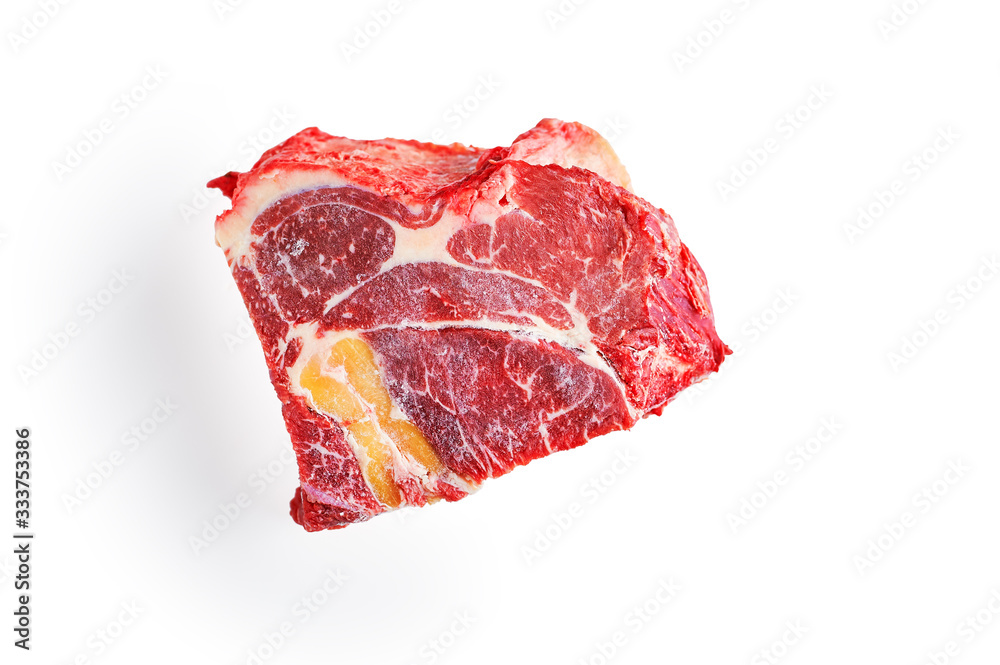 A frozen piece of beef meat with a layer of fat on an isolated white background.