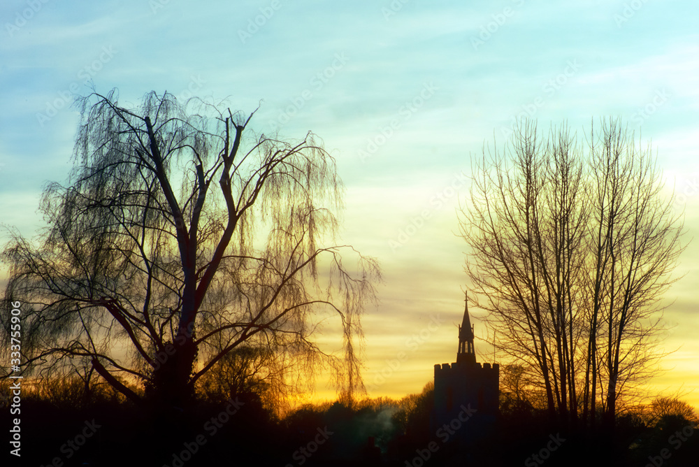 Silhouettes' of the tower church and trees in winter during sunset over the Boxford Village Silhouettes' of the tower church and trees in winter during sunset over the Boxford Village
