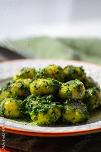 Tasty vegetarian food, italian potato gnocchi with green spinach filled with mozzarella cheese