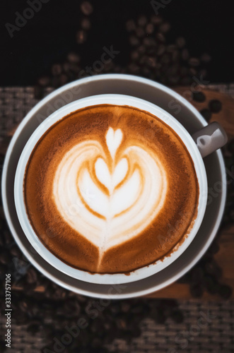 Closeup Coffee latte art leave from fresh milk foam on side of wood