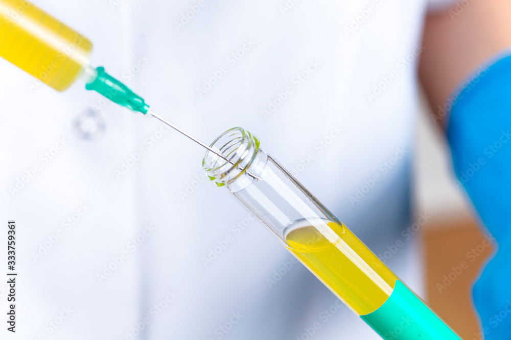 Young female doctor doing a blood test in a laboratory. drug and medical vaccine finding studies. health concept. Young female doctor doing a blood test in a laboratory. drug and medical vaccine finding studies. health concept.