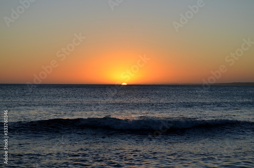 Sunset on the beach with calm sea