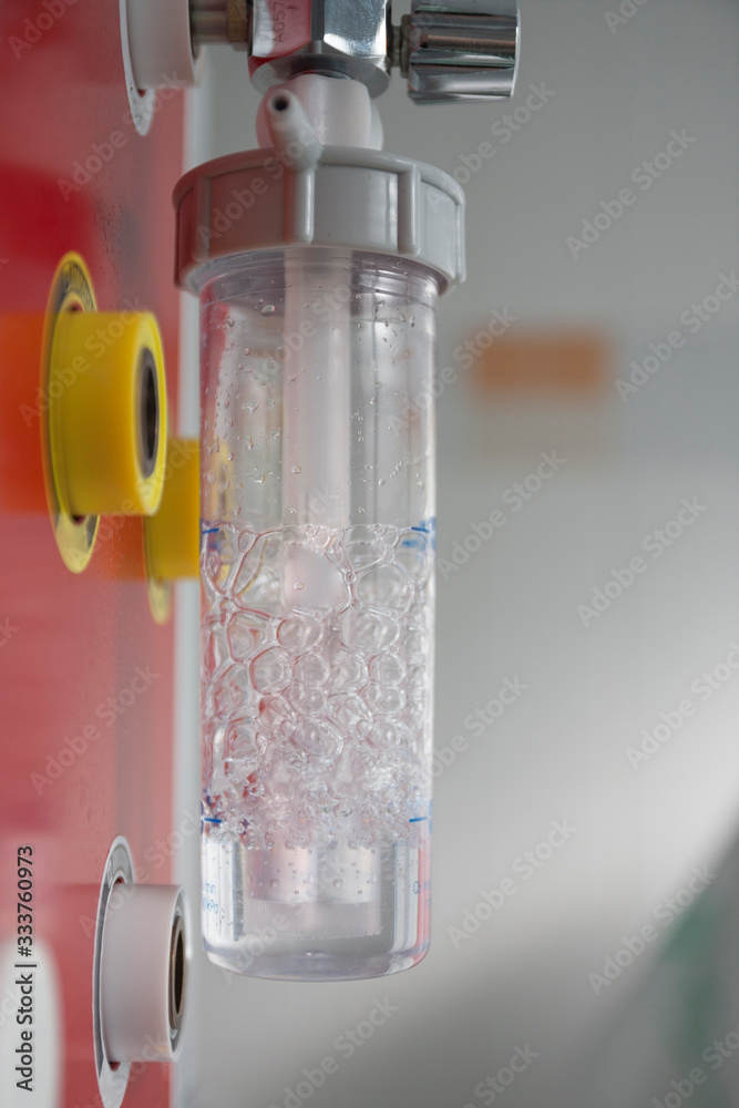 Medical oxygen flow meter with humidification bottle. Oxygen therapy is