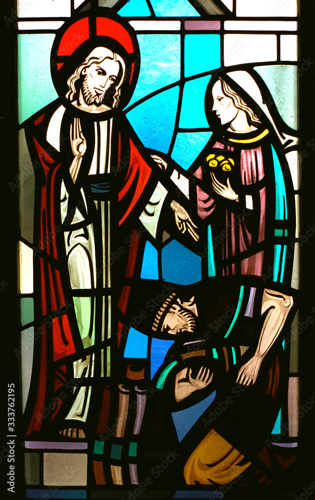 Stain glass of Christ healing sick.