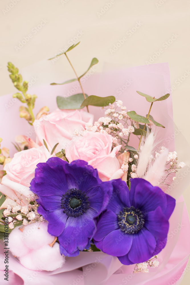 beautiful tender wedding bouquet of cream roses and blue plumeria flowers in hands of the bride. Closeup Modern bridal style. beautiful tender wedding bouquet of cream roses and blue plumeria flowers in hands of the bride. Closeup Modern bridal style.