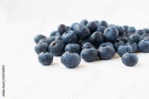A handful of blueberries. Isolated on grey background.