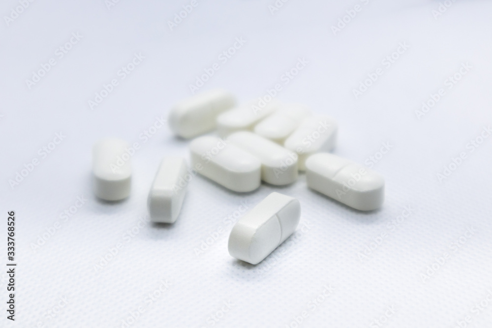 White long health drug pills on white background