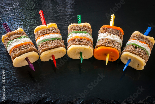 Sandwich multi-colored composition on a glossy black background.