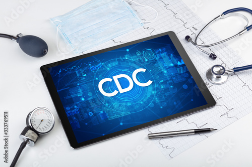 Close-up view of a tablet pc with CDC abbreviation, medical concept photo