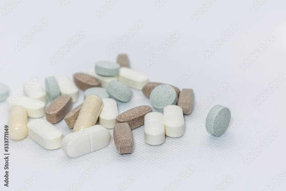Colored health drug pills on white background Colored health drug pills on white background