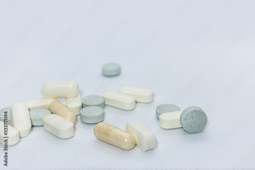 Colored health drug pills on white background Colored health drug pills on white background