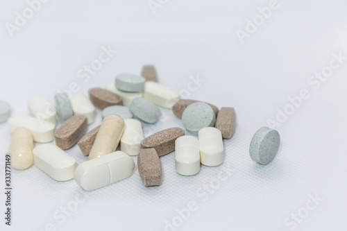 Colored health drug pills on white background