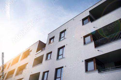 Modern apartment building flat estate concept. Outdoor residential facility at sunset and sunrise.