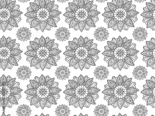 Seamless pattern of hand-drawn black mandalas on a white background. Hindu and Buddhist round sacred symbols in the form of flowers with repeating elements. For wallpaper, fabric, textile. Vector.