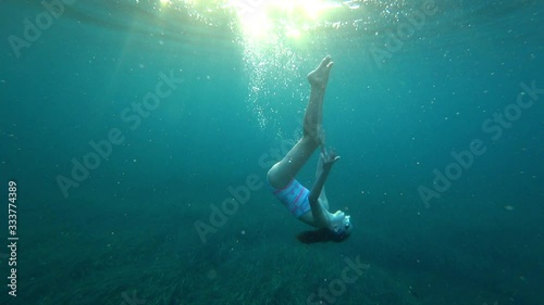 Wallpaper Mural Young girl snorkeling underwater in deep blue sea with air bubbles Torontodigital.ca