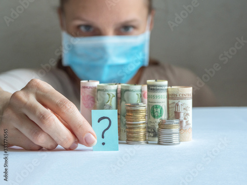 Question mark and money. Pandemic and the economic crisis of the concept