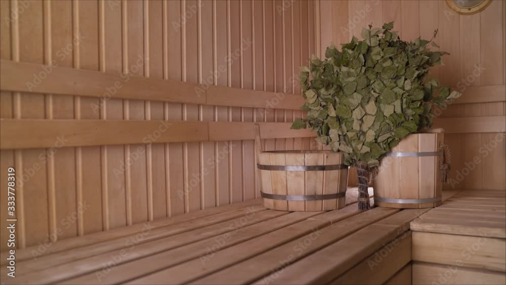 wooden Finnish sauna, shooting objects in the the empty steam room. Broom in the sauna. wooden Finnish sauna, shooting objects in the the empty steam room. Broom in the sauna.
