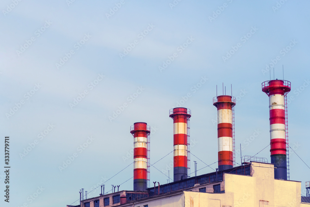 high factory exhaust pipes against a blue sky, urban air pollution high factory exhaust pipes against a blue sky, urban air pollution