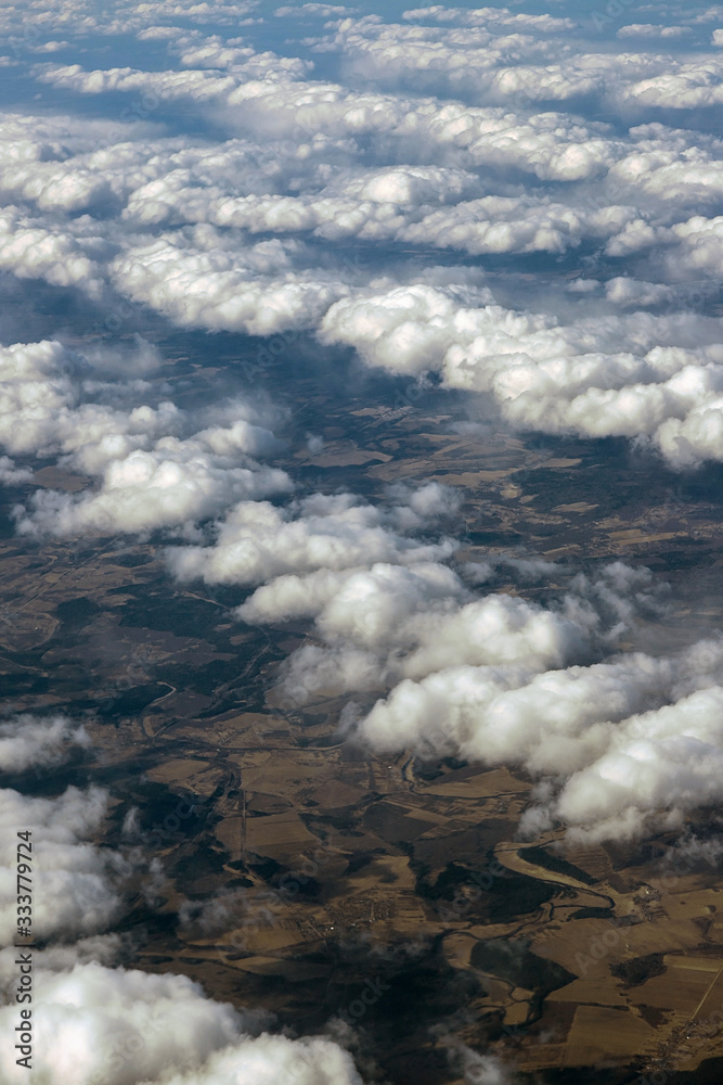 View of the clouds from the plane. Smooth bands of clouds. patterns from clouds. small clouds.