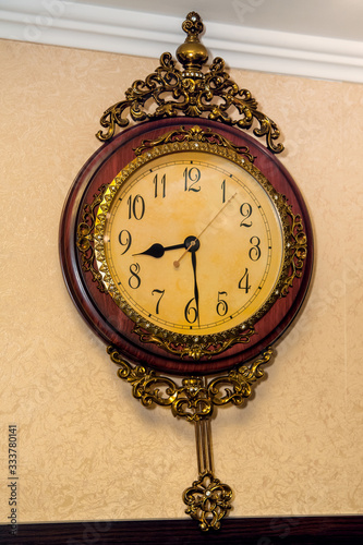 Old wooden clock hanging on the wall