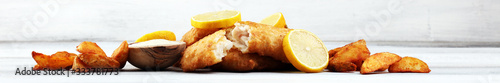 Photography traditional British fish and chips consisting of fried fish, potato chips and ma