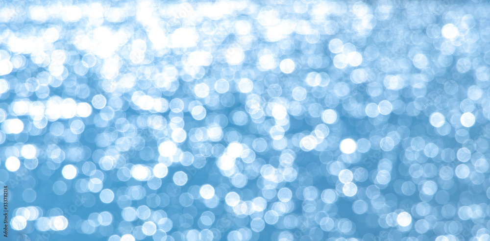 Abstract light blue background with white bokeh_