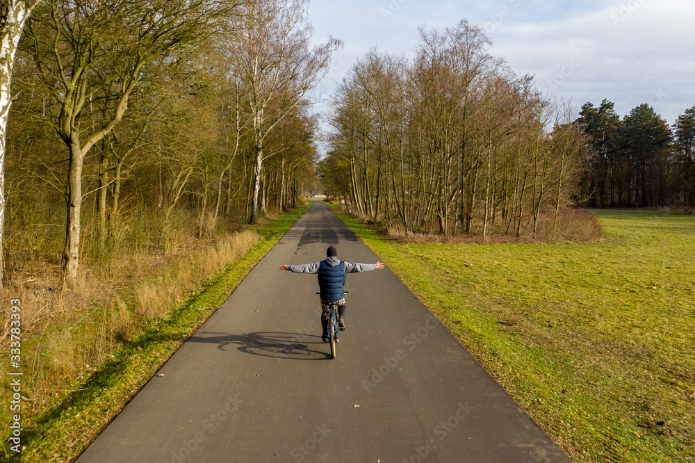 Man riding a bicycle with open arms Man riding a bicycle with open arms