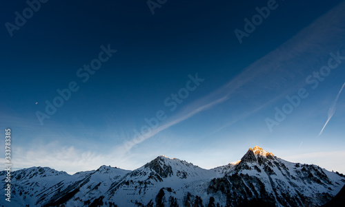 panoramic of mountains chain at sunrise. only one pic is illuminated