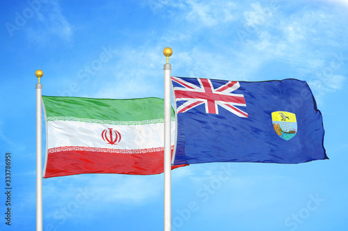 Iran and Saint Helena two flags on flagpoles and blue cloudy sky photo