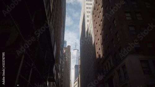 Skyscrapers and office buildings in New York City lower Manhattan's Financial Districit. Low angle view. Multiple buildings surrounding the One World Trade Center from a distance. High contrast.