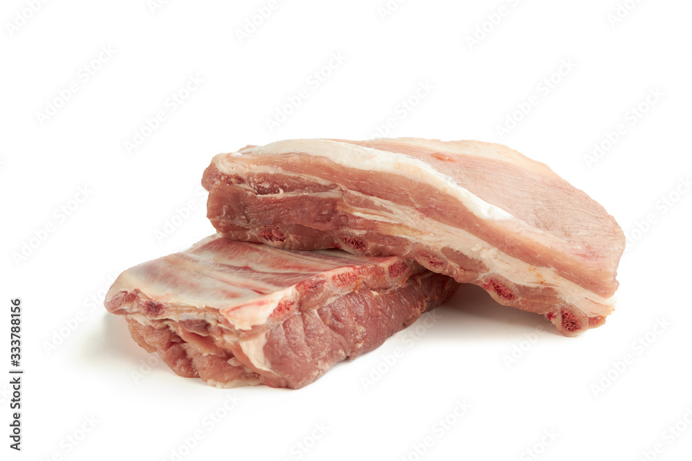 fresh raw pork ribs isolated on a white background. two pieces. ingredient for meat cuisine. side view