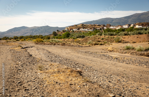 dry riverbed of Nacimiento river with a view of Finana town, province of Almeria, Andalusia, Spain