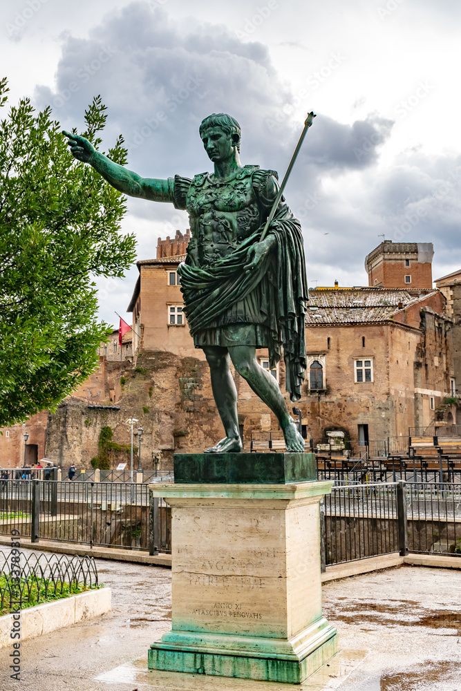 Rome, Italy. Bronze statue of Roman Emperor Augustus Caesar on Via dei Fori Imperiali street in the city. Inscription: SPQR IMP CAESARI NERVAE F TRAIANO OPTIMO PRINCIPI. ANNO XI A FASCIBVS RENOVATIS.