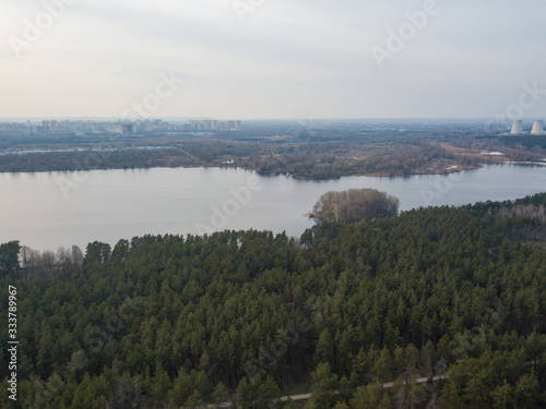 A lake near a coniferous forest on the outskirts of Kiev. Aerial drone view.