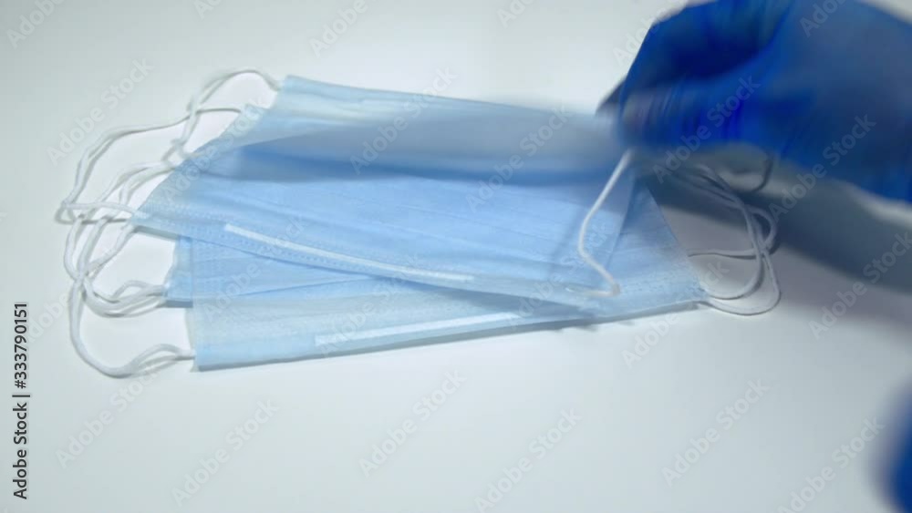 Surgical Masks Picked up by Hands in Latex Medical Gloves Surgical Masks Picked up by Hands in Latex Medical Gloves