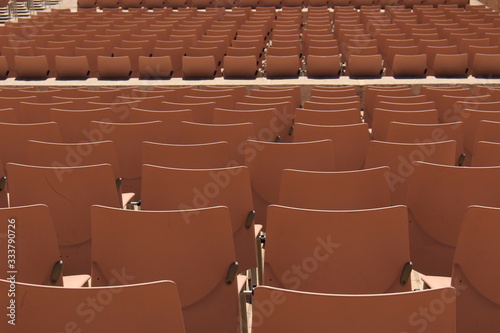 Empty light brown seats at an outdoor festival.