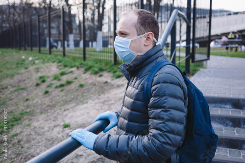 Wallpaper Mural The portrait of sad man in blue surgical mask and gloves on the street. Pandemic coronavirus 2020. Quarantine.Virus concept. Epidemic infection. Torontodigital.ca