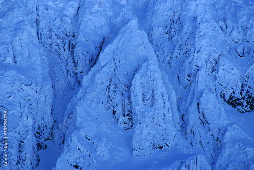 Winter alpine landscape in National Park Retezat, Carpathians, Romania, Europe. Snow covered moutains scenery