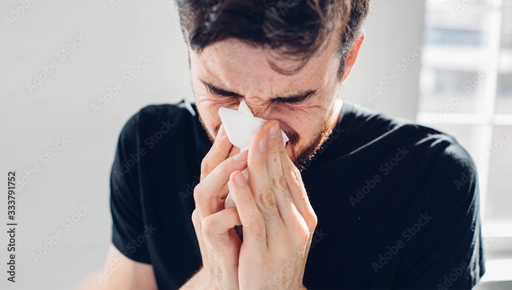 Sick guy isolated has runny nose. Using white napkin. Coronavirus danger. Ill male person inside studio room. Sick guy isolated has runny nose. Using white napkin. Coronavirus danger. Ill male person inside studio room.