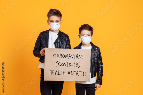 Prevention against Covid-19 Coronavirus. People wearing protective face masks and holding the sign Coronovirus (covid-19) Health allert photo