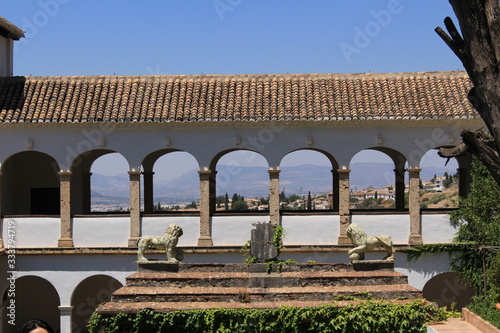 Court of the Sultana’s Cypress Tree (Patio de la Sultana) with two lion statues at Generalife gardens at Alhambra palace and fortress complex in Granada, Andalusia, Spain. photo