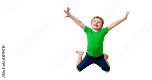 Happy little kid boy in green t-shirt on white background