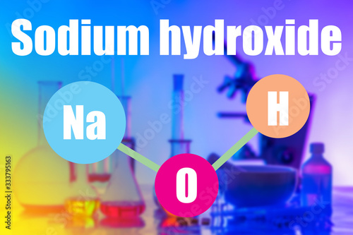 Inscription NaOH on the background of the laboratory. Concept - caustic substances are investigated in the laboratory. The inscription Sodium hydroxide on the background of the microscope. photo