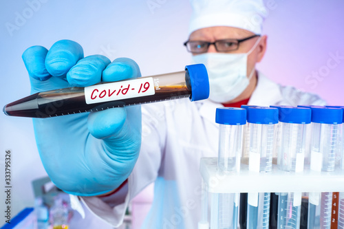 Doctor holds out test tubes...