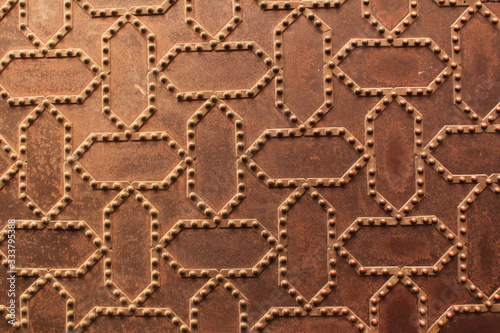 Metal door pattern of Nasrid Palaces (Palacios Nazaries) at the historical Alhambra Palace complex in Granada, Andalusia, Spain.